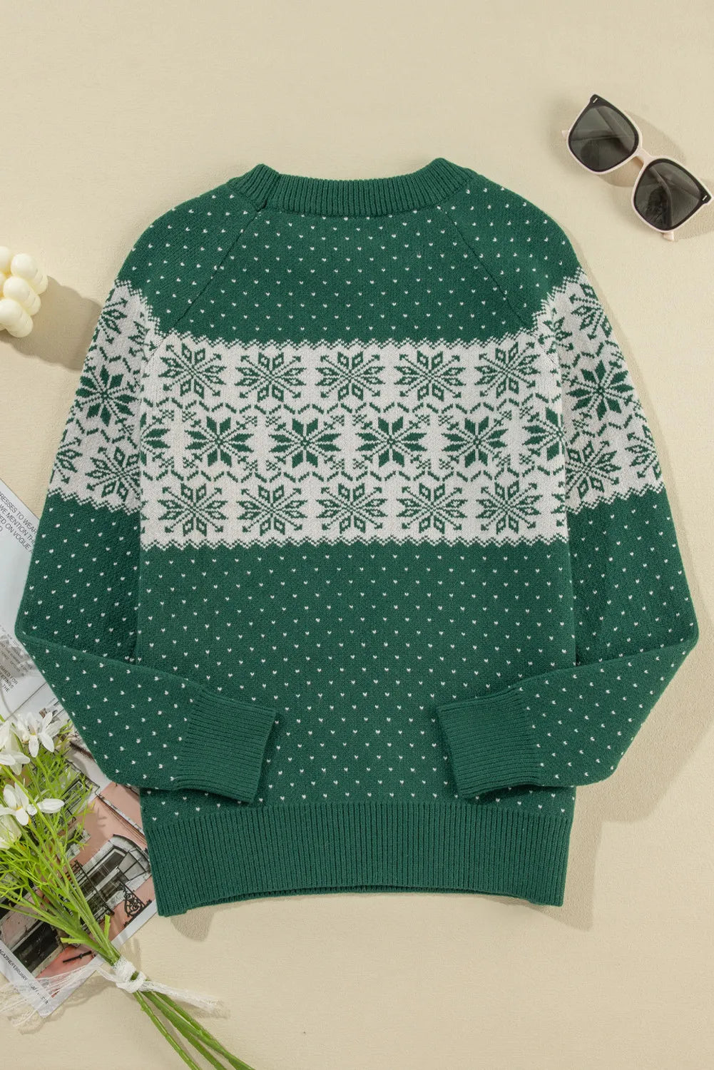 Dark green knit sweater with white snowflake fair isle pattern and small dot print.