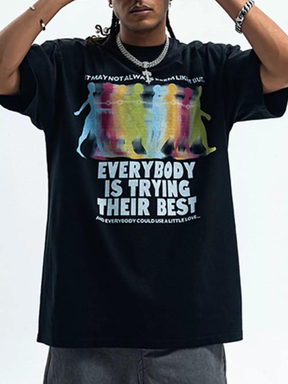 Men's black cotton graphic t-shirt with colorful figures and text print.