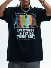 Men's black cotton graphic t-shirt with colorful figures and text print.