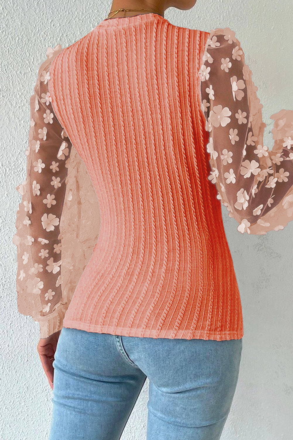 Coral knit top with sheer floral appliqué sleeves