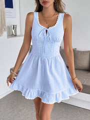 Sky blue gingham mini dress with sweetheart neckline, lace trim, and ruffled hem.
