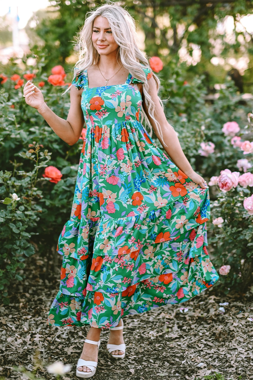 Green floral ruffle-sleeve tiered midi dress with square neckline and colorful blooms.