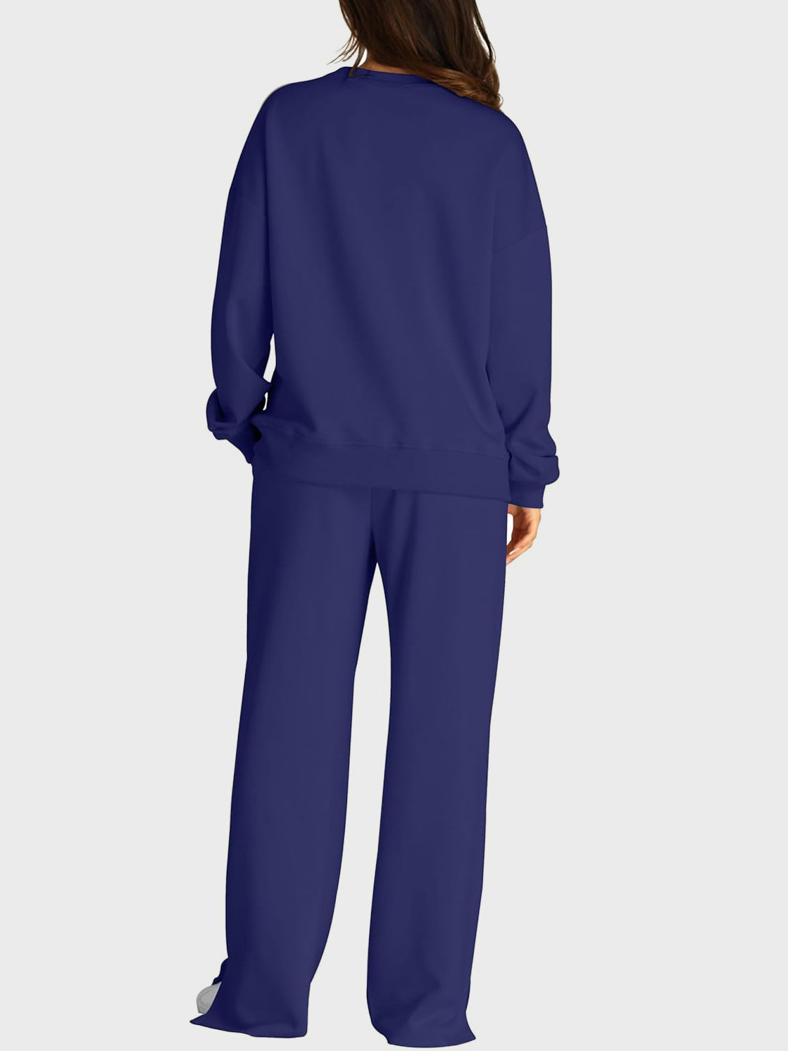 Dark blue loungewear set with crewneck sweatshirt and wide-leg trousers with slit front detail.