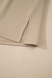 Khaki blouse with textured fabric and side slit detail.