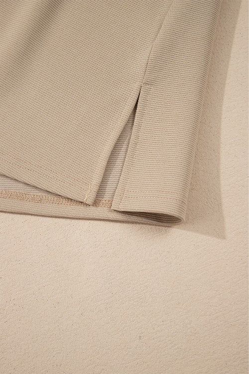 Khaki blouse with textured fabric and side slit detail.