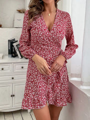 Red floral wrap mini dress with V-neck, long sleeves, and ruffled hem.