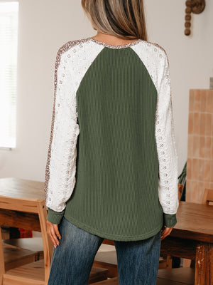 Dark green waffle knit henley top with white lace sleeves and leopard print detail.
