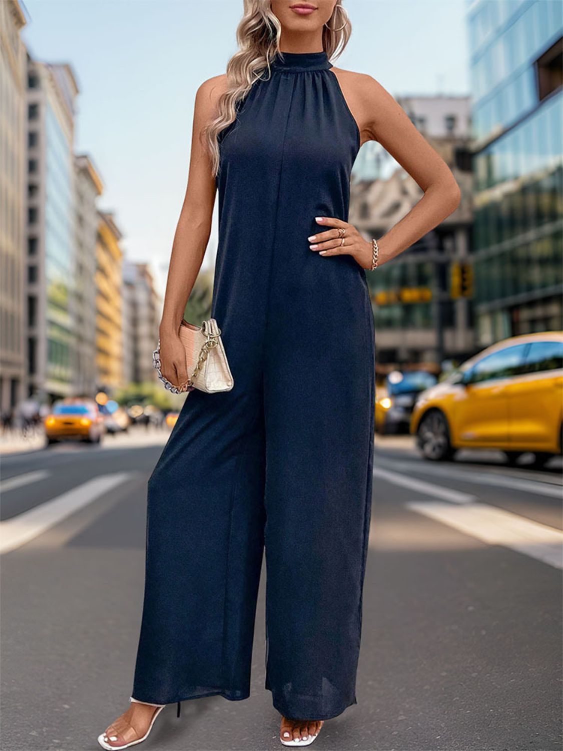 Dark blue halter neck wide leg jumpsuit with backless detail.