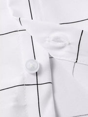 White cotton overshirt with black plaid print, showing button detail.