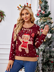 Burgundy knit sweater with gingerbread graphic and "Sweet Christmas" text, crew neck, long sleeves, ribbed cuffs and hem.