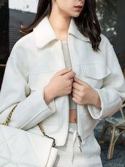 White cropped zip-up jacket with two chest pockets and a collar.