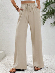 Caramel textured palazzo trousers with drawstring waist and pockets.