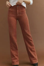 Brown corduroy flared leg trousers with patch pockets and a high waist.