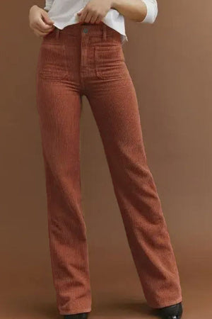 Brown corduroy flared leg trousers with patch pockets and a high waist.