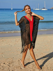 Black crochet cover-up with red V-neck trim and fringe hem