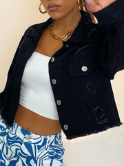 Black cropped distressed denim trucker jacket with frayed hem and collar.