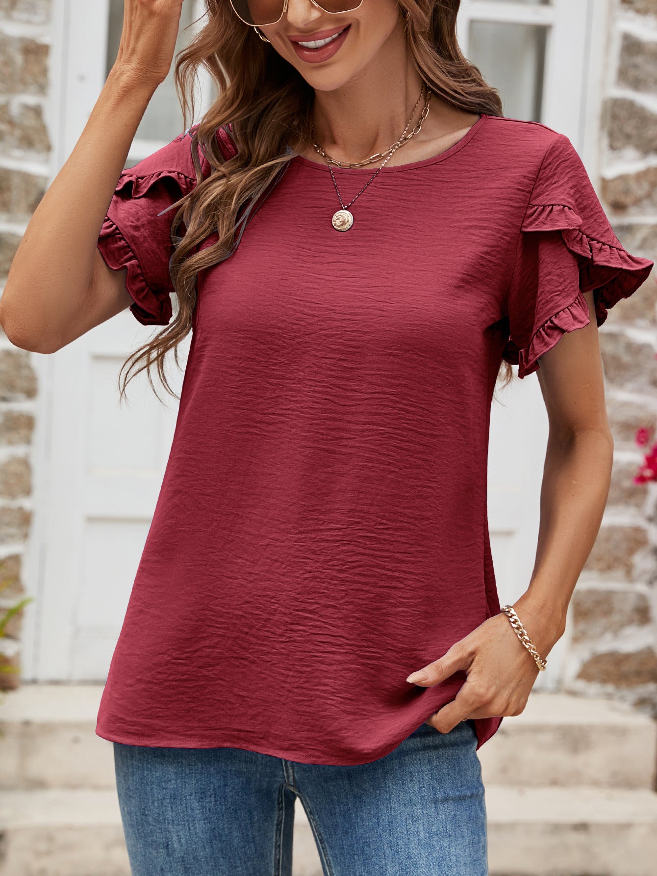 Burgundy t-shirt with textured fabric and ruffled cap sleeves.