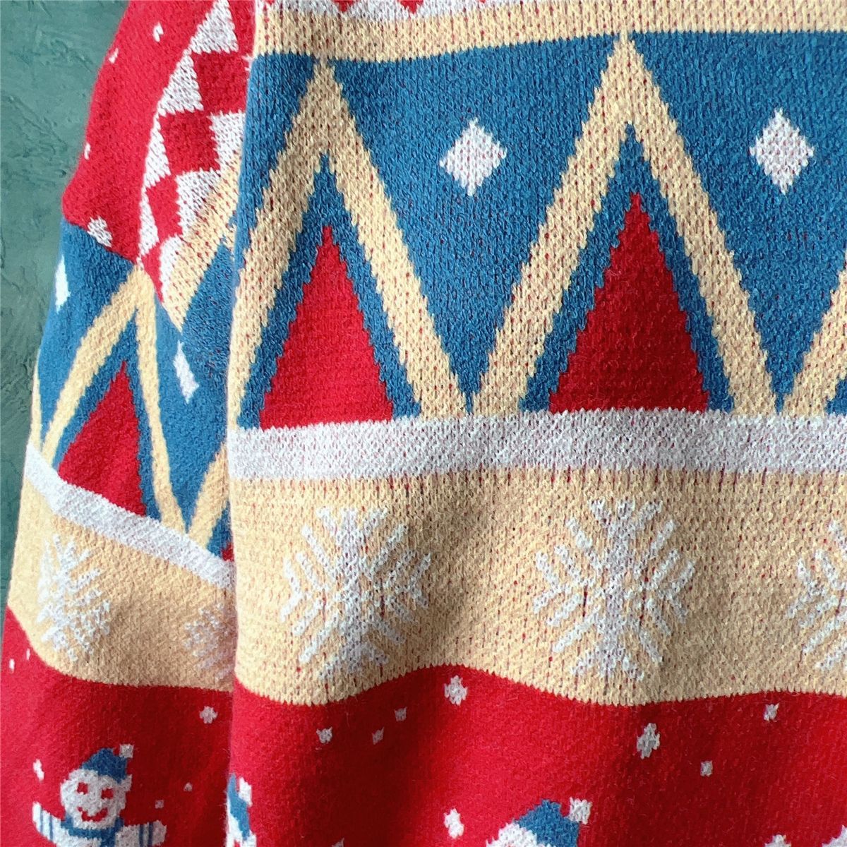 Festive Fair Isle knit jumper in red and sky blue with snowman and snowflake patterns.