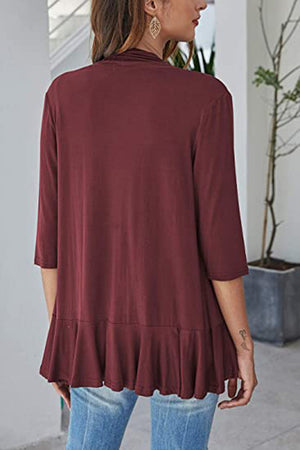 Burgundy cardigan with 3/4 sleeves and asymmetrical ruffle hem detail.