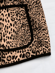 Leopard print boxy jacket with black edge trim and pocket detail.