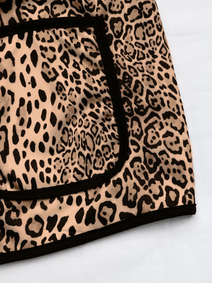 Leopard print boxy jacket with black edge trim and pocket detail.