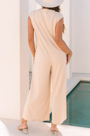 Textured ribbed sleeveless collar jumpsuit in eggshell with wide legs.