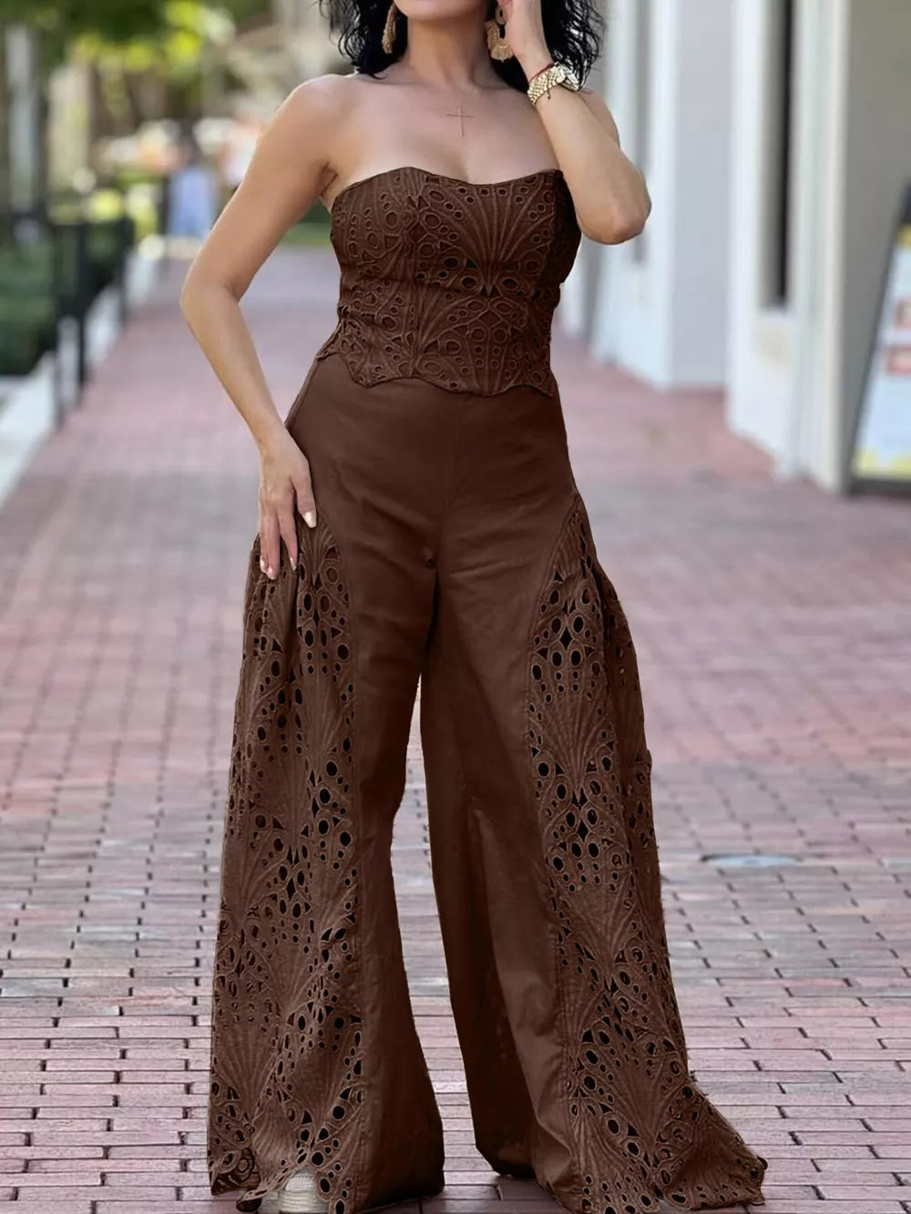 Brown strapless openwork corset top and wide-leg pants set with intricate cut-out details.