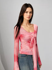 Pink watercolor tie-front t-shirt with flared sleeves and a square neckline.