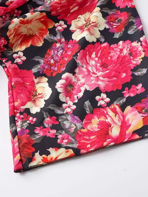Black floral ruffle hem mini dress with vibrant pink and yellow flowers.