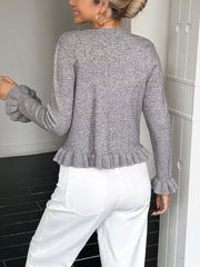 Gray acrylic knit cardigan with ruffled trim on sleeves and hem.