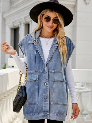 Sleeveless denim utility vest with hood in medium wash, featuring button front and chest pockets.