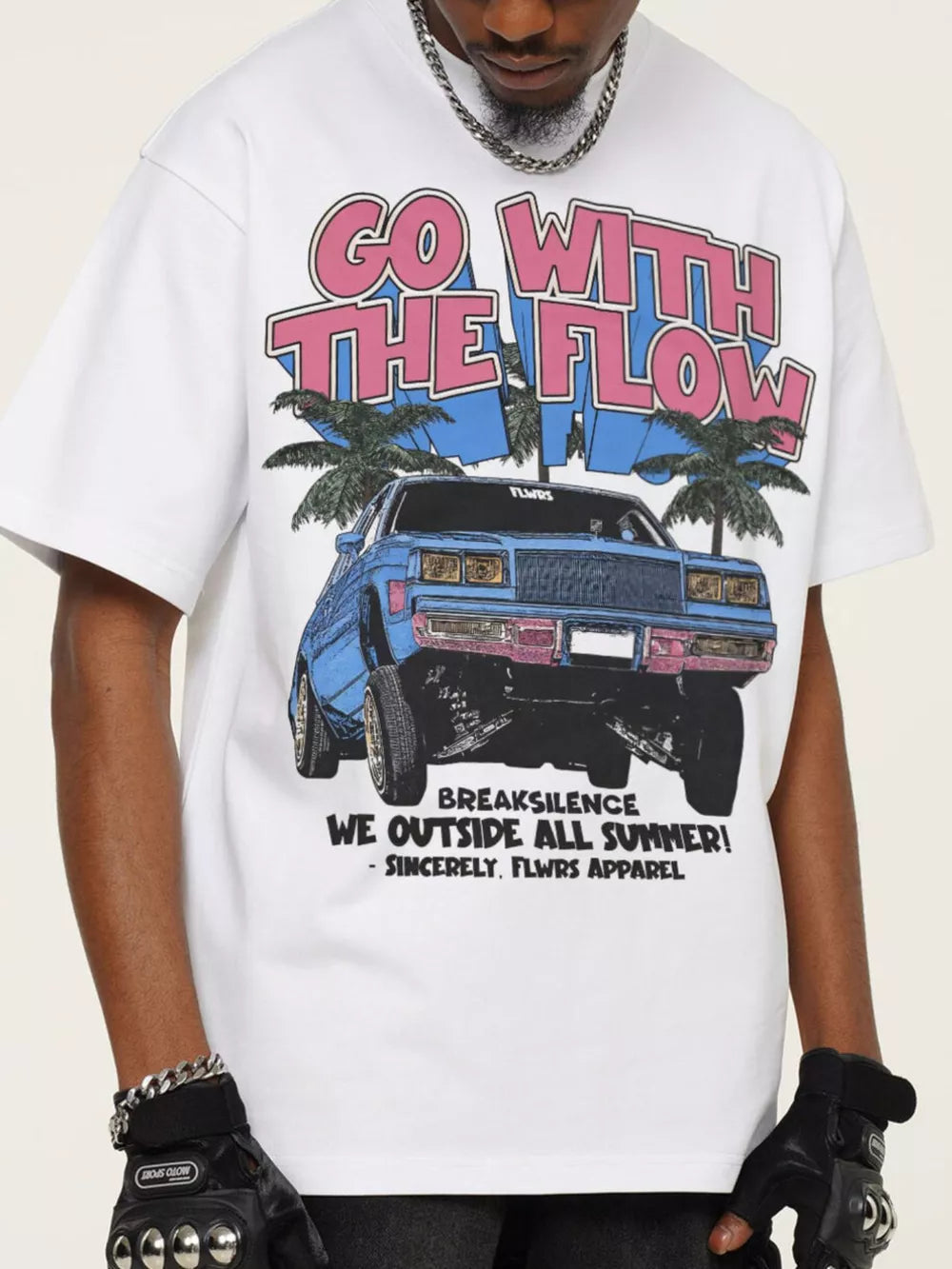 White cotton graphic tee with bold "GO WITH THE FLOW" text and car illustration.