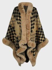 Beige checkered acrylic cape with faux fur trim and pom-poms.