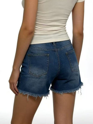 Women's dark blue distressed denim shorts with frayed hem and five-pocket styling.