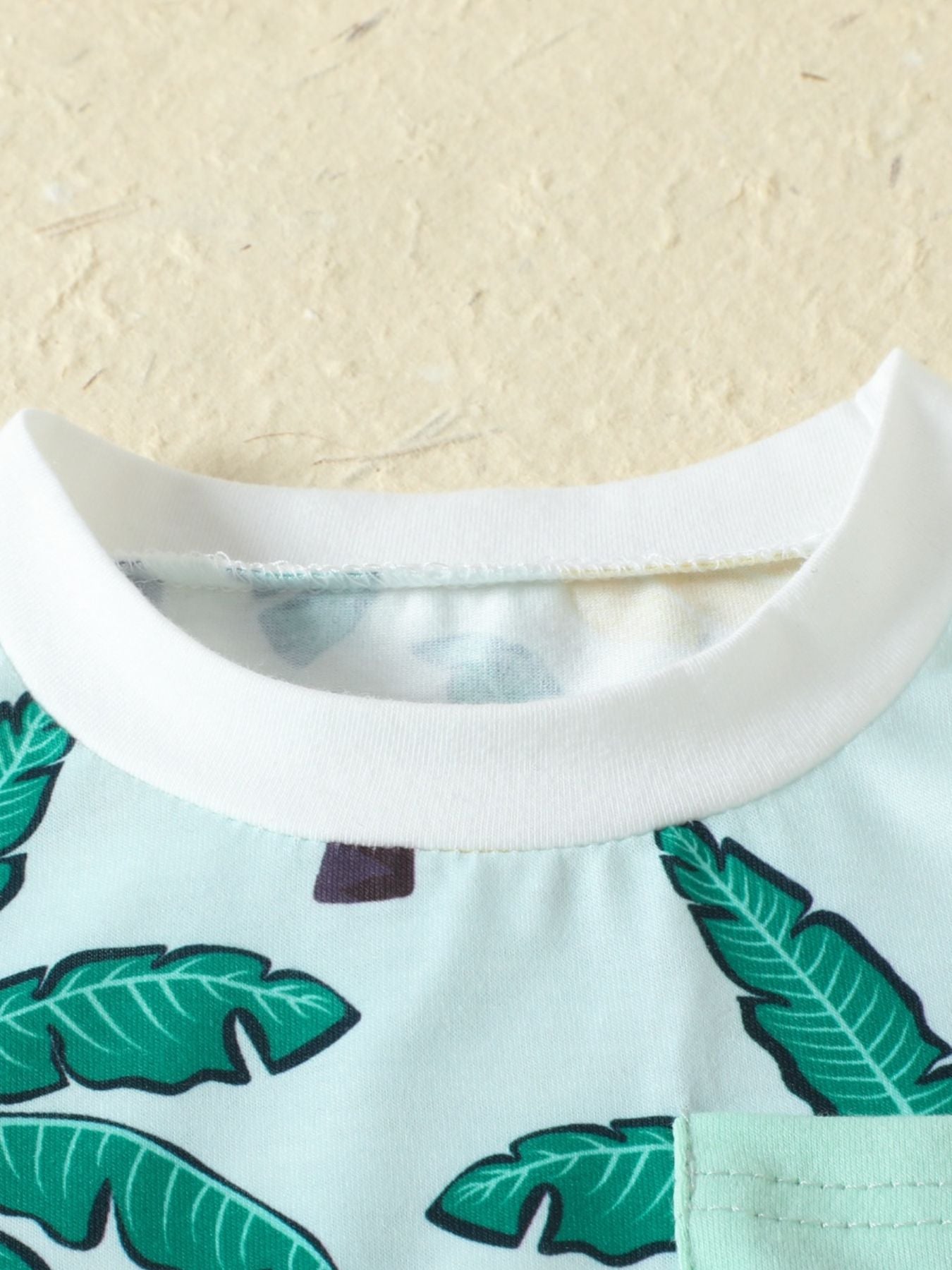 Baby set in French Blue cotton blend with tropical banana leaf print and crew neck.