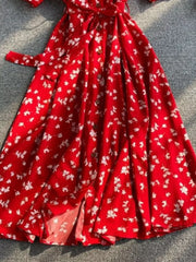 Red floral midi dress with button front, belted waist, and V-neck.