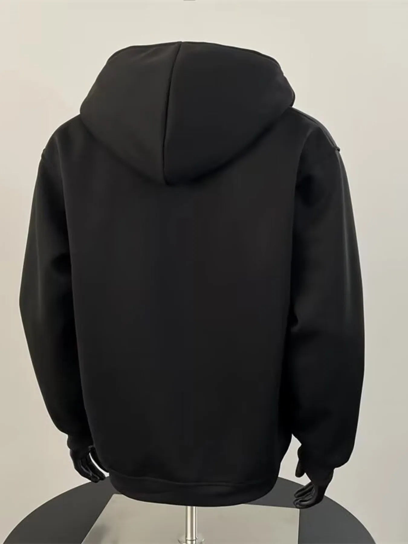 Black zip-up hoodie for men with a comfortable fit and cotton blend material.