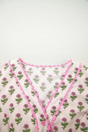 Floral v-neck midi dress in blush pink with scalloped trim and button front.