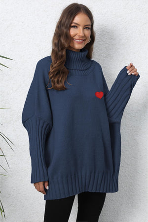 Dark Blue batwing knit turtleneck sweater with red heart embroidery and ribbed sleeves.