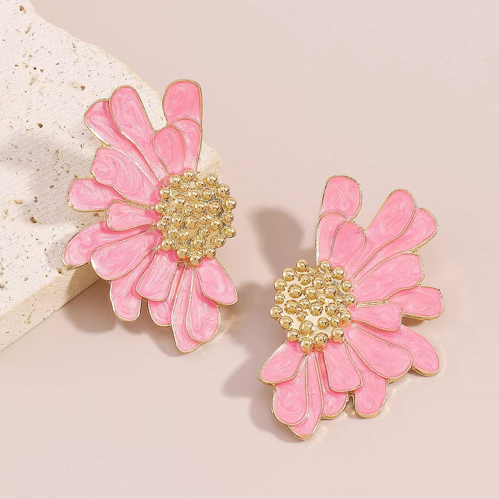 Pink textured flower stud earrings with gold center detail.