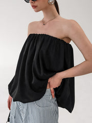 Black strapless bubble hem top with a cinched neckline and flowy silhouette.