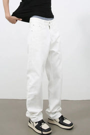 Relaxed fit ivory denim jeans with a straight leg and zip fly, styled casually.