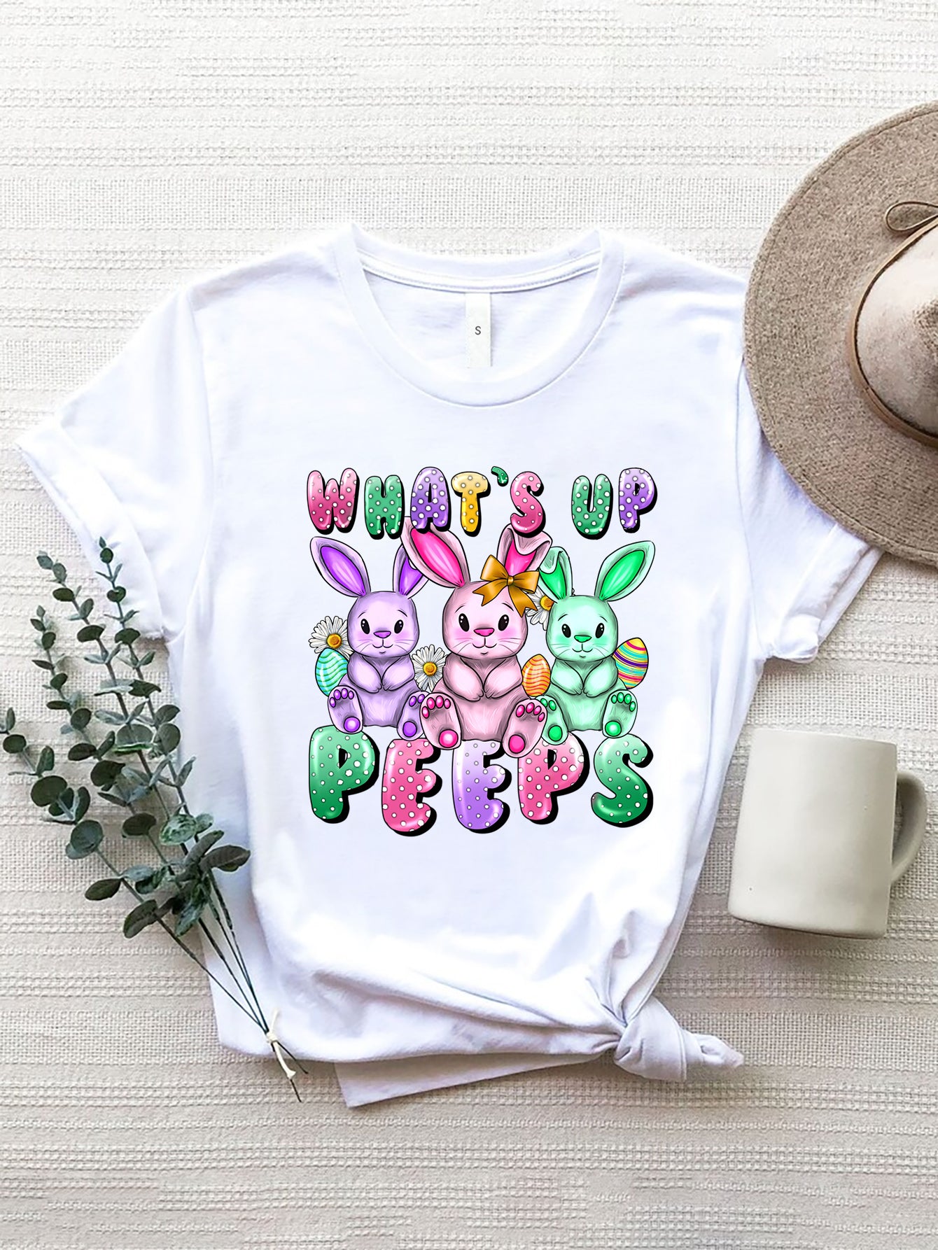 White Easter Bunny graphic tee with "What's Up Peeps" text and three colorful bunnies.