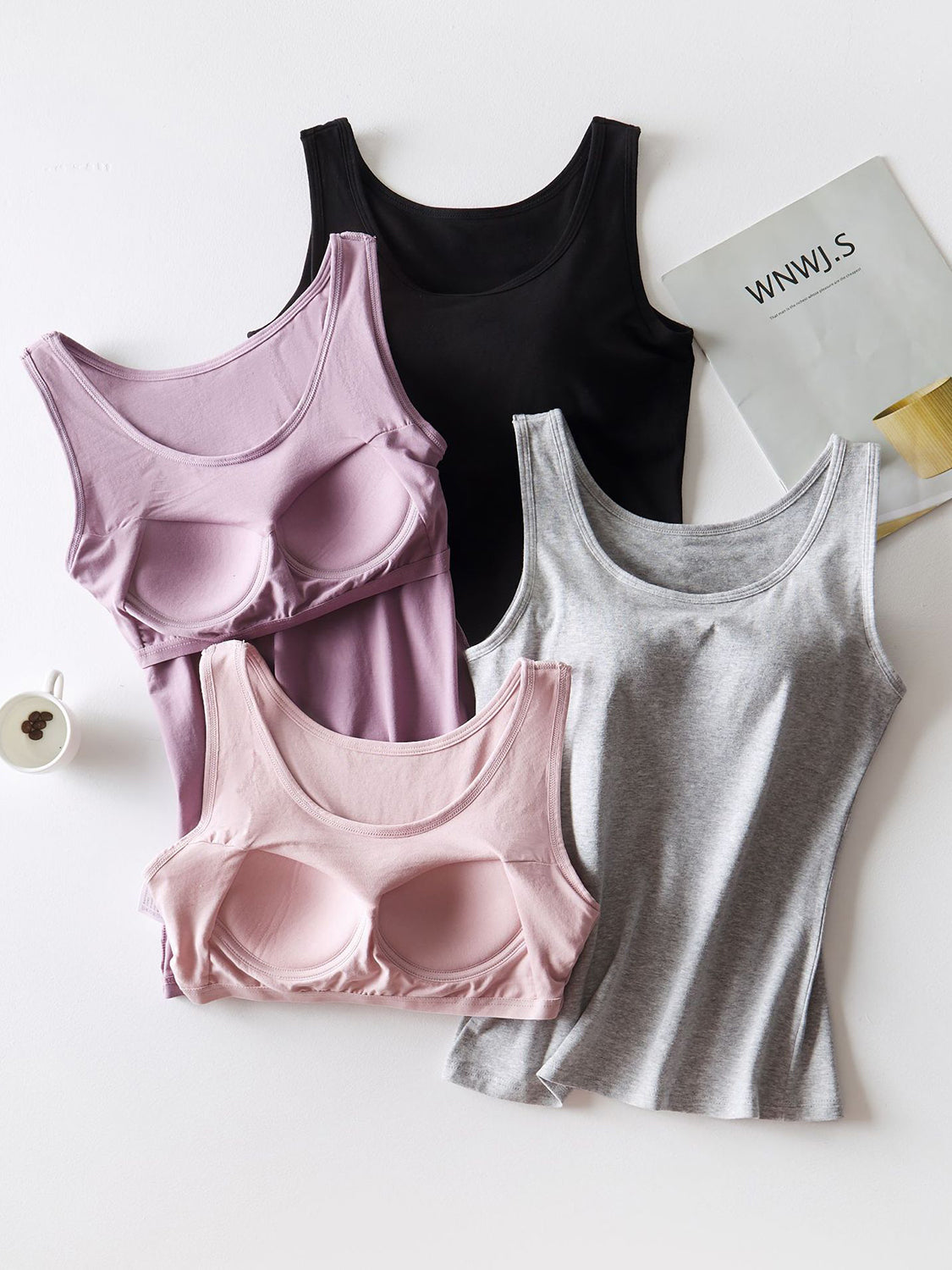 Built-in support tank tops in blush, lilac, gray, and black with scoop necks.