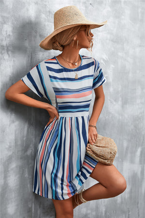 Striped yoke-seam trapeze dress with short sleeves and elastic waist in multi-color stripes.