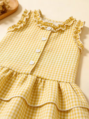 Yellow gingham baby dress with ruffled neckline and tiered skirt.