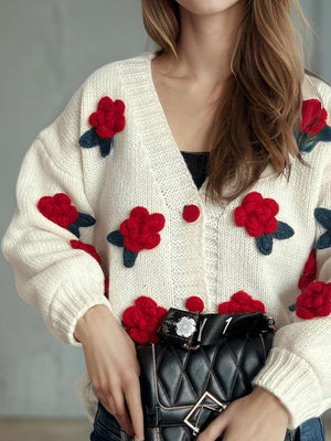Cream knit cardigan with red embroidered rose appliqués and button front.