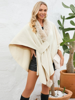 Cream faux fur collar wrap poncho with tie belt and pom-pom detail.