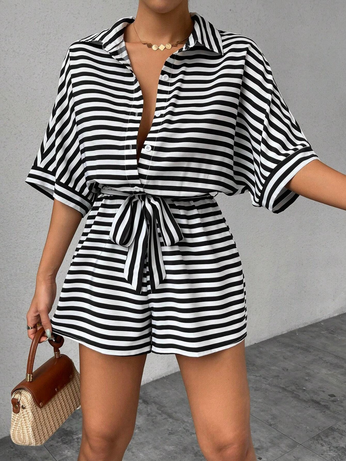 Black and white striped shirt romper with self-tie belt and button front.
