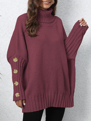 Burgundy turtleneck sweater with button cuff detail and ribbed sleeves.